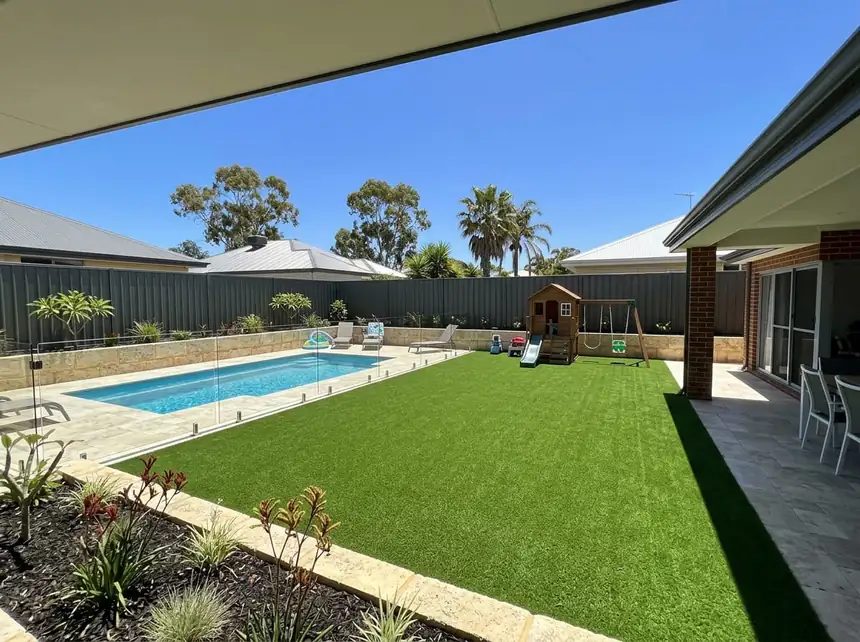 Artificial grass Mandurah — completed synthetic turf backyard with pool fence and planting