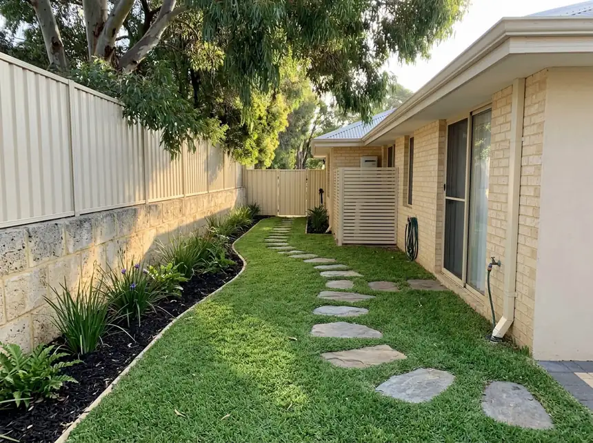 Artificial turf courtyard with stepping stones and native planting