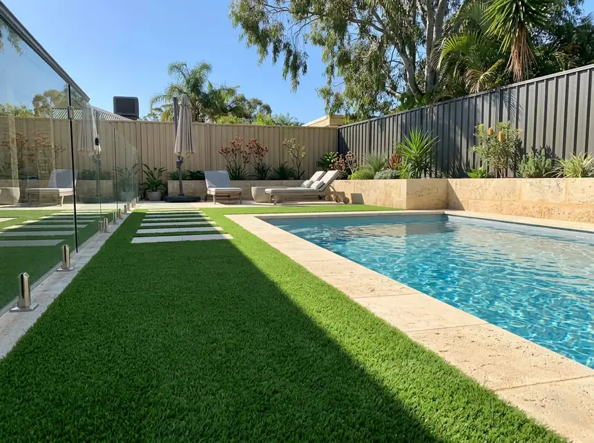 Artificial turf pool surround with limestone coping in Mandurah