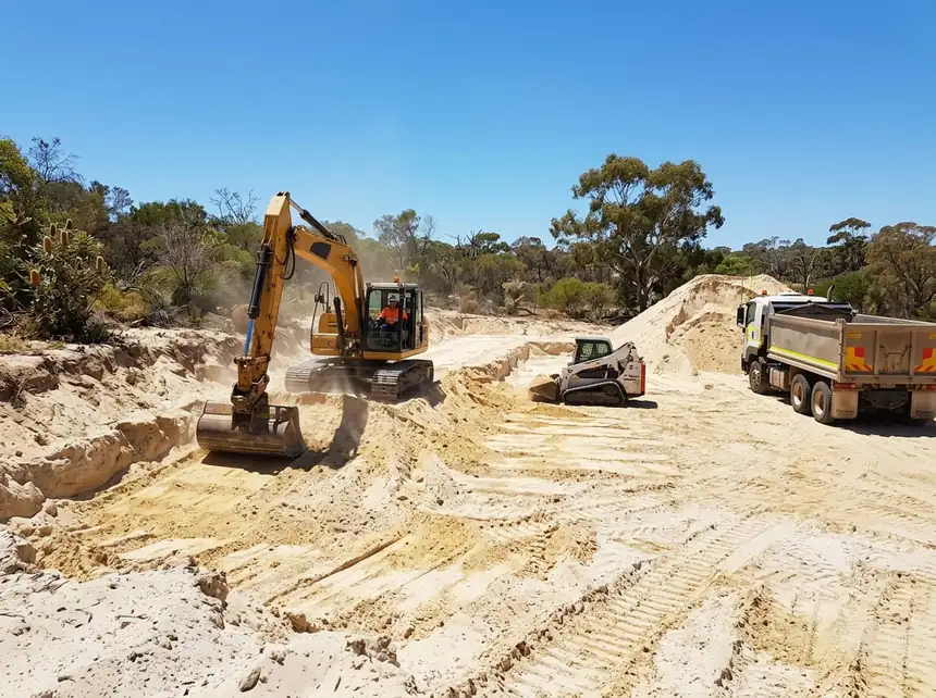 Earthworks Mandurah — excavator and bobcat cutting levels on a sand block