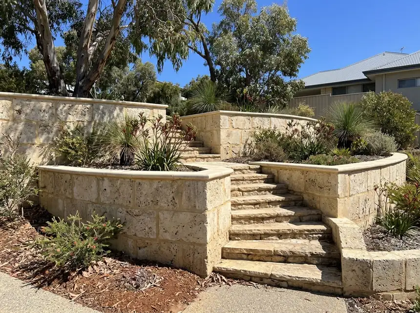 Limestone block retaining wall and steps on a sloping Peel region block